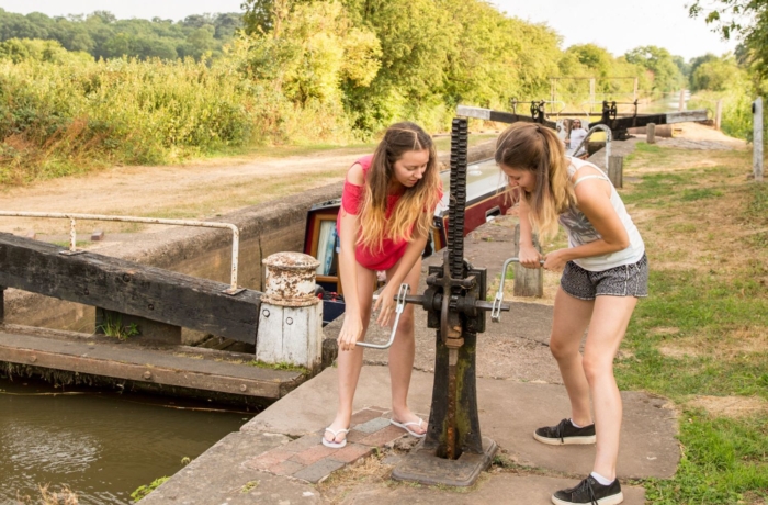 teenagers working lock on canal