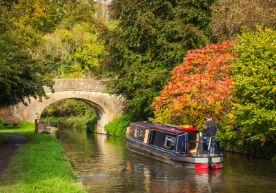Father and son at the tiller of a narrowboat